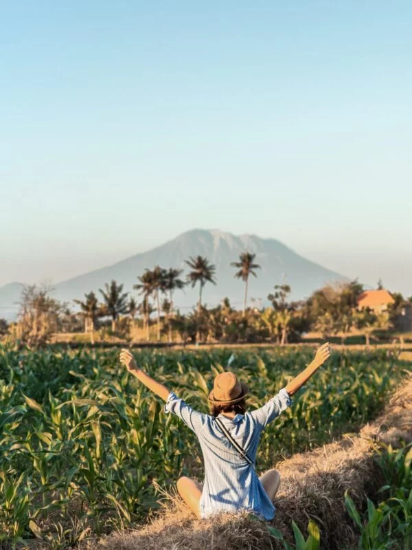 A student sitting in a field on a school trip
