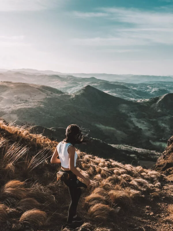 A student hiking on a hillside in Costa Rica