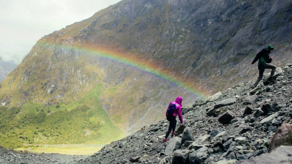 Hiking on a mountain with a rainbow on an overseas school trip