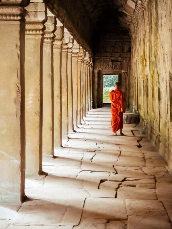 A monk in a temple hallway in Cambodia